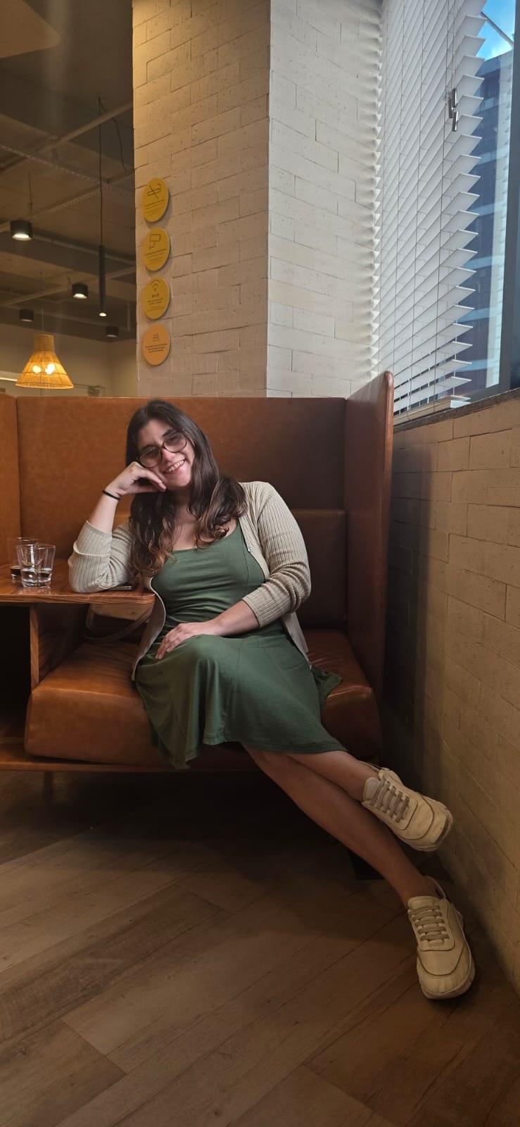 Lorena Porto sentada de forma descontraída em uma poltrona